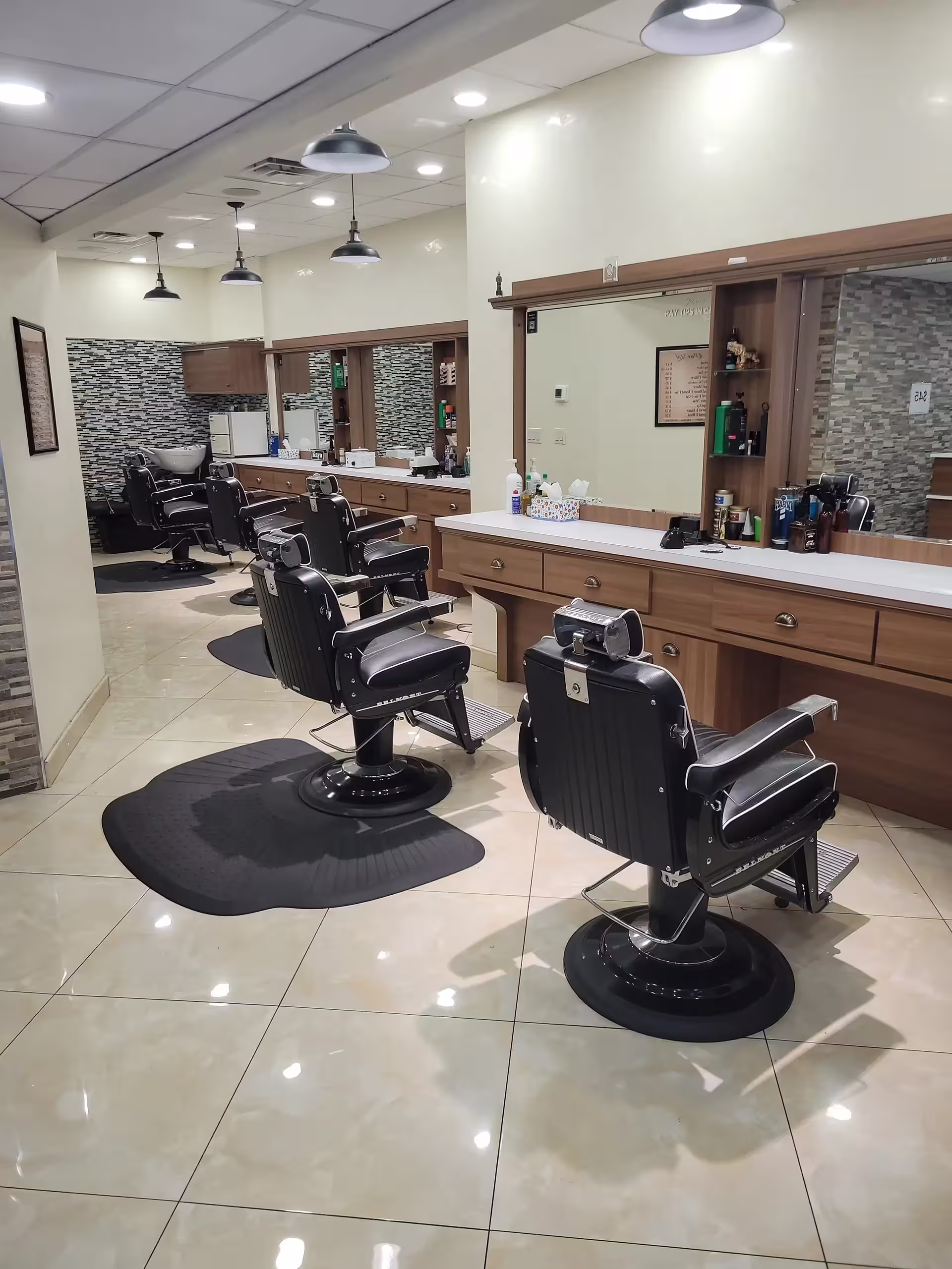 Modern hair cutting floor at Prime Barbershop in Chelsea, NYC, featuring vintage barber chairs and professional grooming stations.